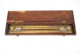 A vintage brass sliding rule marked Nav School No 29, J Halden & Co LD. In a mahogany box.