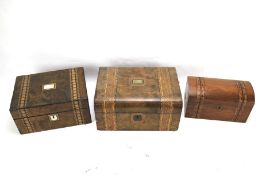 Three late 19th century walnut and mahogany inlaid wooden boxes.