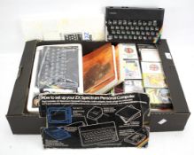 Two Sinclair ZX Spectrums and an assortment of related items.