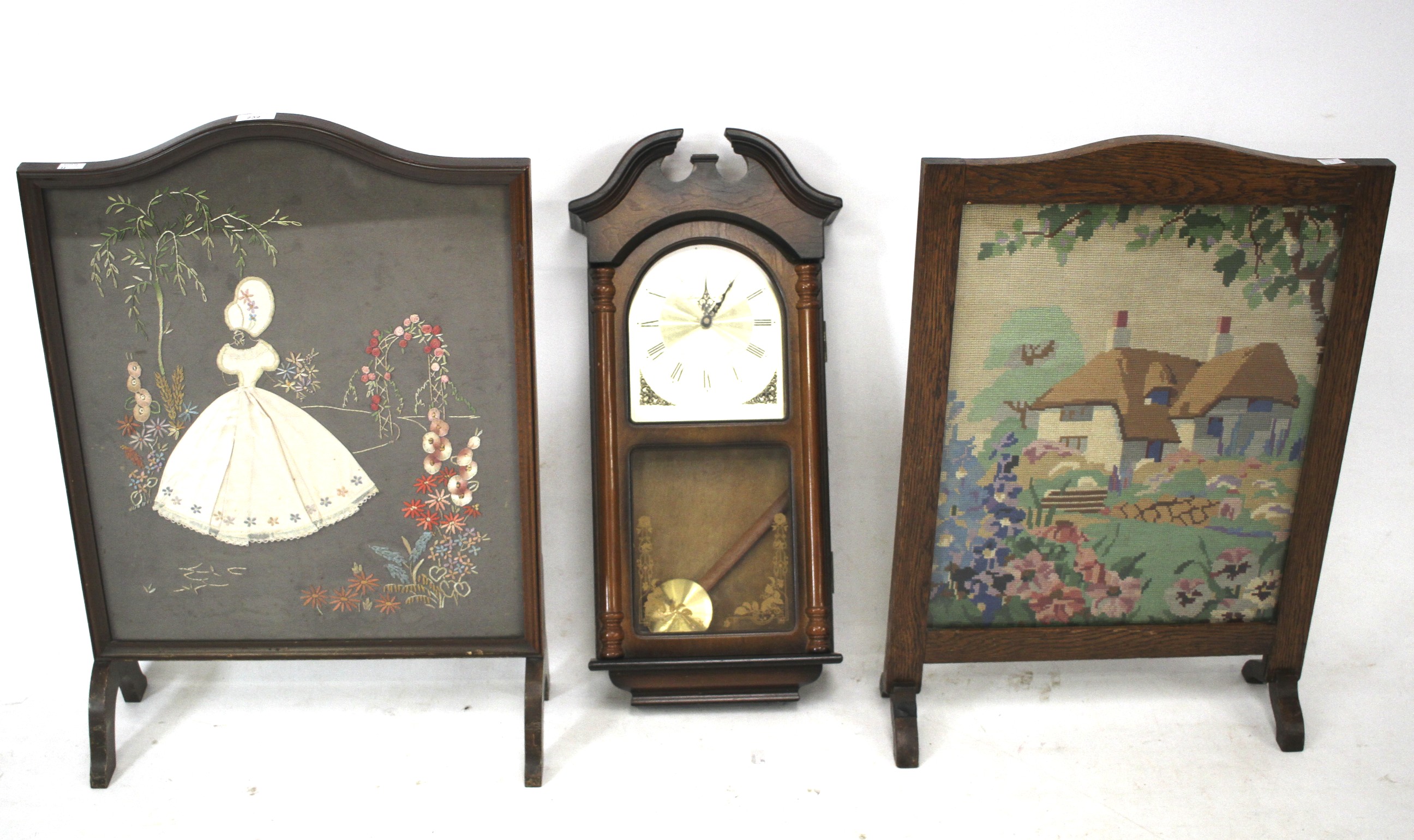 Two fire screens and a wall mounted clock.