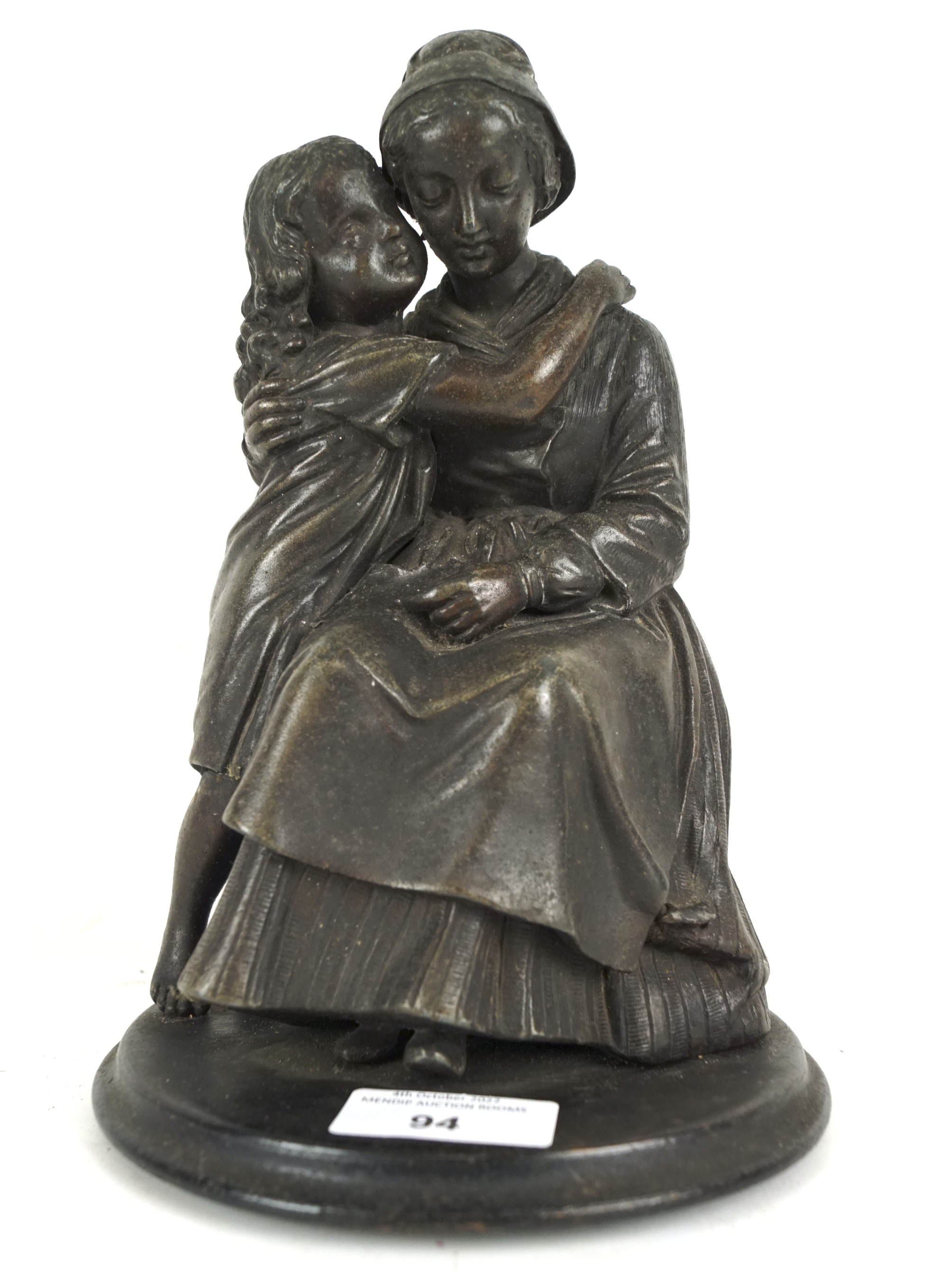 A 20th century spelter figure depicting a mother and child.