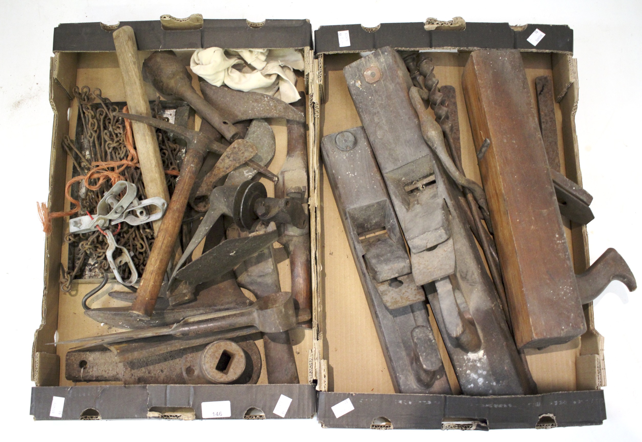 Two boxes of vintage hand tools including cobbler shoes and farm implements.