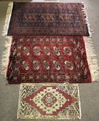 Three assorted rugs.