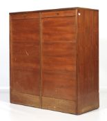 A 1960s teak roll front filing cabinet.