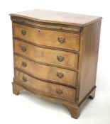 A reproduction mahogany chest of drawers. WIth veneer serpentine, four drawers and slide.