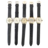 A collection of five mechanical wrist watches.