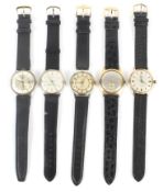 A collection of five mechanical wrist watches.