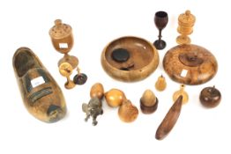 An assortment of treen and other wooden collectables. Including a Dutch clog, dishes, fruit, etc.