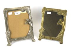 An Art Nouveau brass mirror frame and a white metal picture frame.