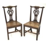 A pair of Georgian oak dining chairs.