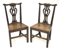 A pair of Georgian oak dining chairs.