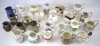 A collection of English porcelain and pottery milk-jugs.