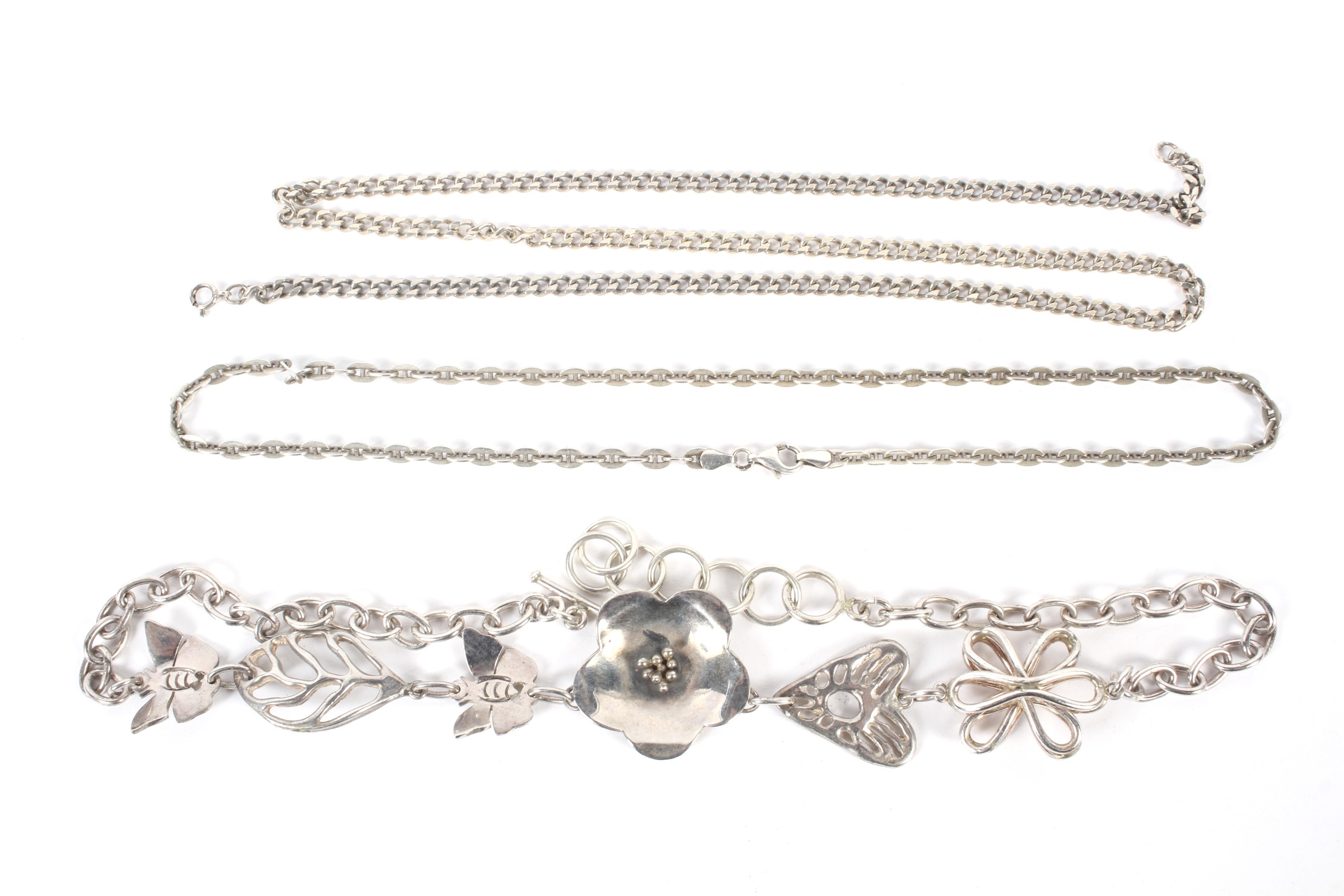 Three assorted silver chains. One decorated with bumble bees and flowers, total weight 93.1 grams.