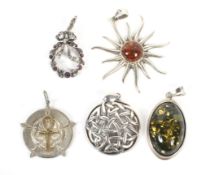 A collection of five ladies white metal pendants.