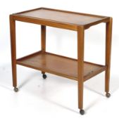 A mid-century Remploy teak two-tier teak trolley. Raised on casters.