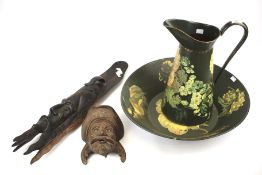 A wash bowl and jug set and two wooden carved heads.