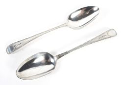 A pair of Georgian serving spoons with engraved decoration to the handles.