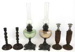Two Victorian coloured glass oil lamps and two pairs of candlesticks.