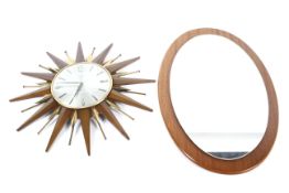 A Metamec starburst clock and an oval mirror.