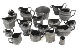 A group of 19th-20th century English black basalt and Jackfield-type pottery jugs.