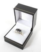 A 9ct gold dress ring. Set with three sapphire and diamonds, weight 3.4 grams, size Q.