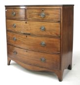 A mahogany veneer bow-fronted chest of drawers.