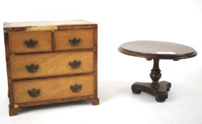 An early 20th century apprentice piece tilt top table and veneered chest of drawers. The chest L19.