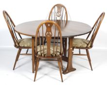 A set of four Ercol dark stained swan back dining chairs and a round, drop leaf dining table.