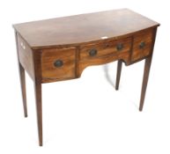 A Regency mahogany bow fronted kneehole dressing or side table with three drawers.