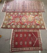 Three assorted Eastern rugs.