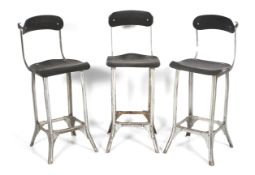 Three metal and black stained plywood industrial style high chairs.