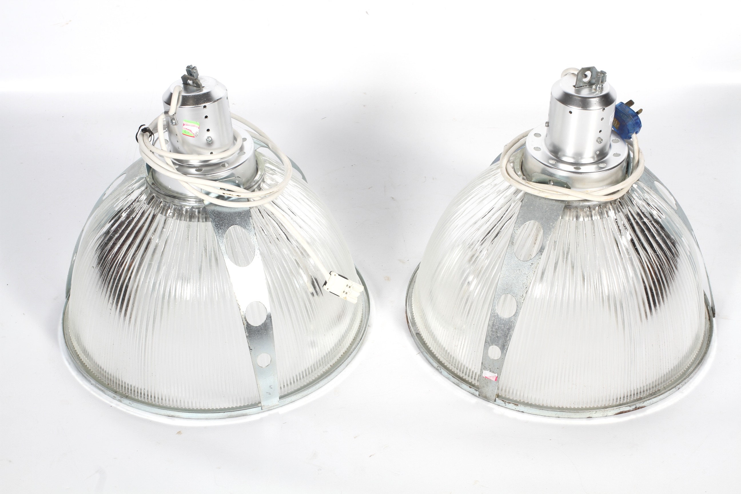 Two Holophane ribbed glass industrial style pendant lights with chromed fittings.