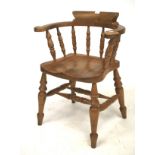 A pine elbow chair. With turned spindles and turned supports united by turned stretchers, H81cm.