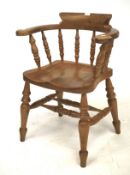 A pine elbow chair. With turned spindles and turned supports united by turned stretchers, H81cm.
