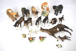 A collection of Beswick pottery animals and others.