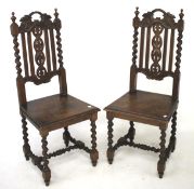 A pair of oak hall chairs.