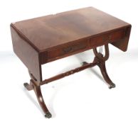 A reproduction Regency style mahogany drop leaf table.