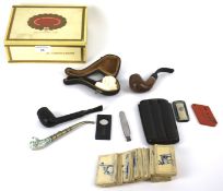 A box of smoking paraphernalia. Including pipes, cigarette cards, cigar items in a Cuban cigar box.