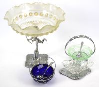 A glass and silver plated table centrepiece and three dishes.