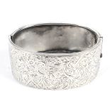 A silver Victorian hallmarked cuff bangle with engraved decoration. Weight 37.5 grams.