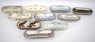 A collection of 19th century Staffordshire pottery toothbrush boxes and covers.