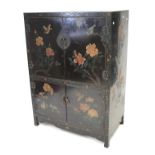 A lacquered Chinese style cabinet with upper and lower cupboard.