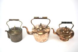 Three vintage copper kettles of various shapes and sizes.