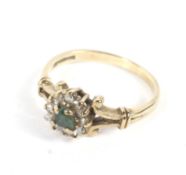 A 9ct gold emerald and diamond dress ring. The centre stone surrounded by twelve diamonds. Weight 2.
