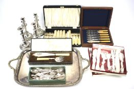 A silver plate tray, various flatware, some boxed, and two pairs of candlesticks.