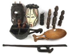 An assortment of mostly African tribal carved wood items.