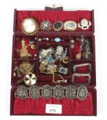 A burgundy Morocco jewellery case with an assortment of costume jewellery.