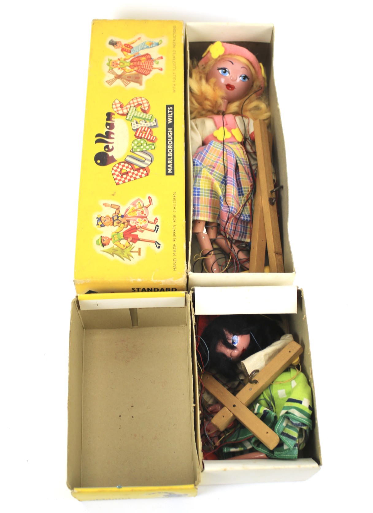 Two boxed Pelham puppets.