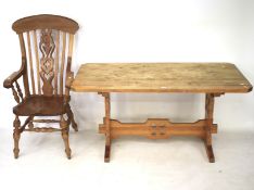 A pine refectory table and a modern elm seated Windsor chair.