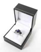 A white metal dress ring stamped 10k. Set with simulated sapphires and diamonds, weight 3.
